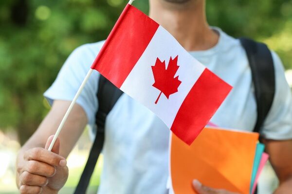 Student holding Canadian Flag